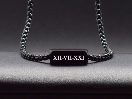 Black rectangular pendant with custom Roman numerals on a black chain